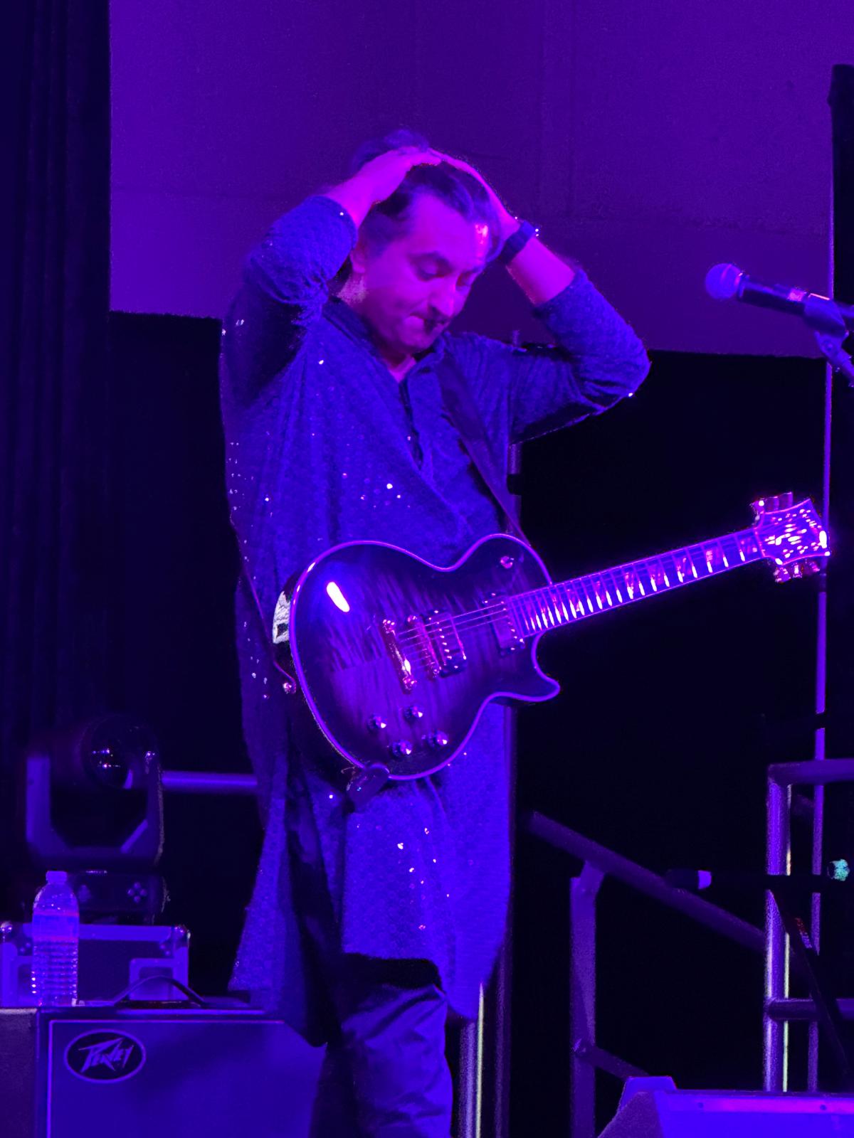 Guitarist in purple stage lighting
